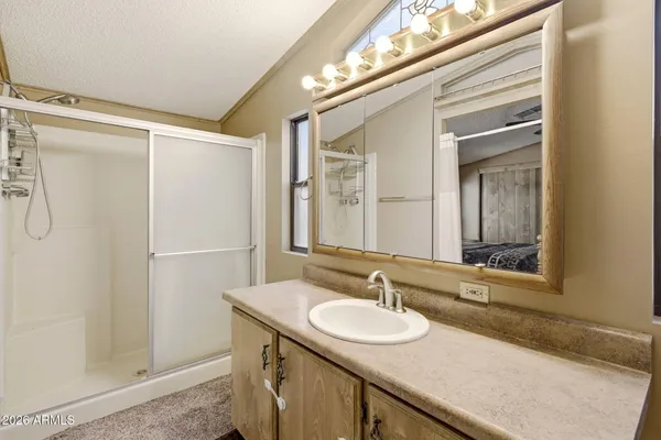 a bedroom with a bed and a ceiling fan