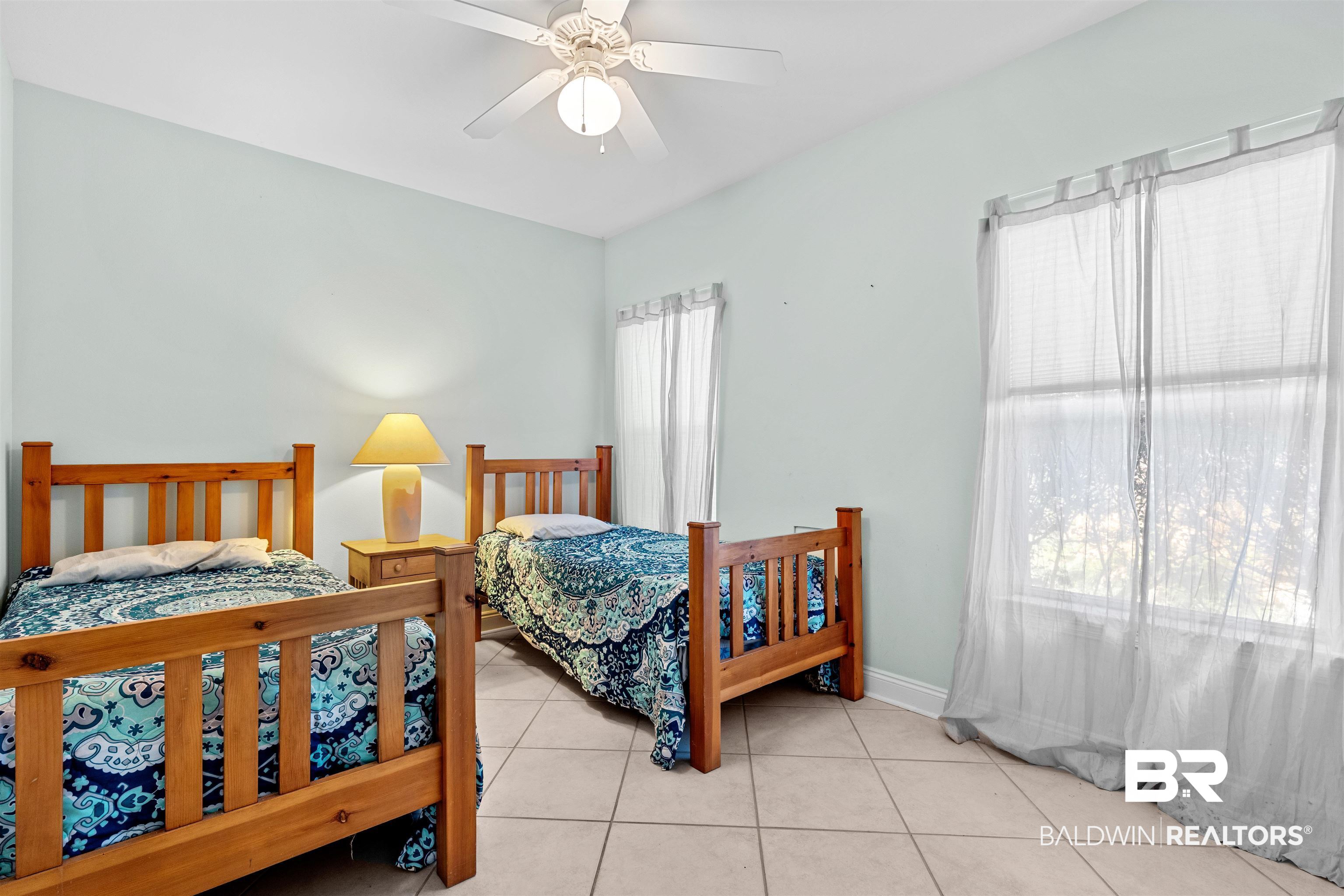 237 Hemingway Loop Foley, AL 36535 - Photo 18 of 49 Tiled bedroom featuring a ceiling fan and baseboards