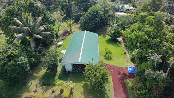 an aerial view of a house with a yard
