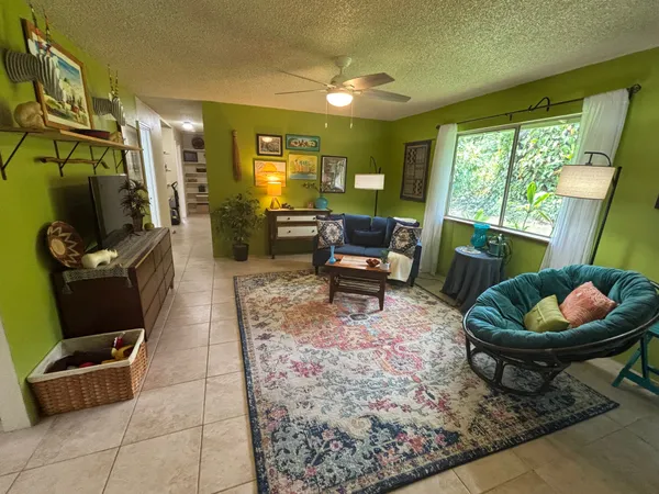 a living room with furniture and a floor to ceiling window