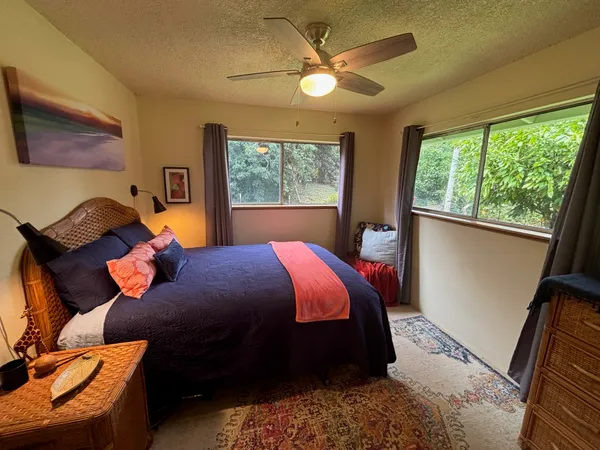a bed sitting in a bedroom next to a window