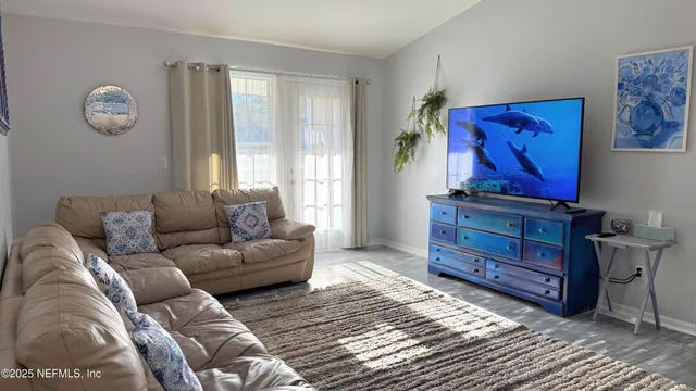 a living room with furniture a bed and a window