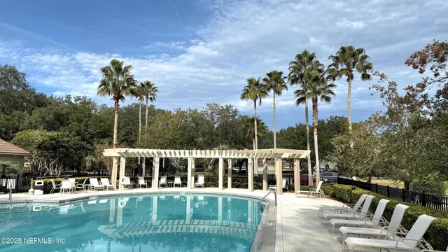 a view of a house with backyard outdoor seating and hardwood