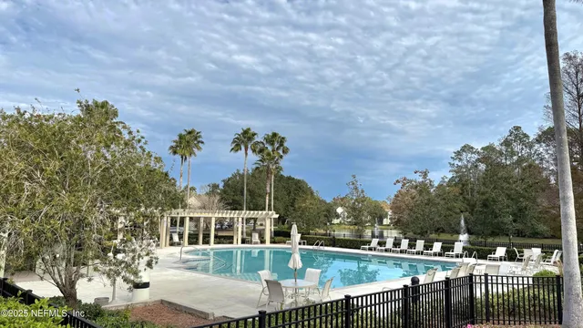 a view of a house with a swimming pool and sitting area