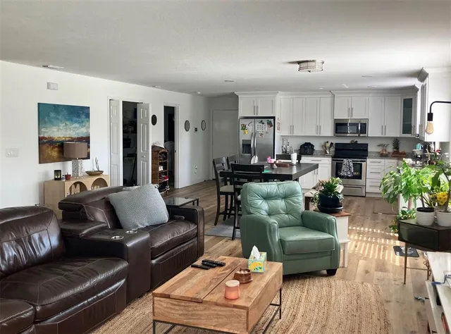 a living room with furniture fireplace and a wooden floor