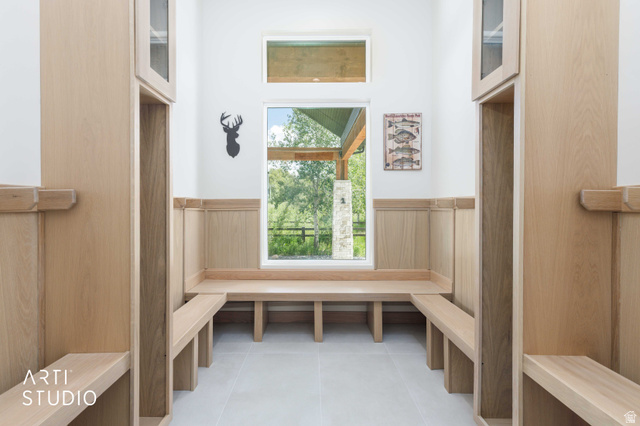 1188 South Old Trappers Loop Road Huntsville, UT 84317 - Photo 21 of 92 Built-in wood-finish benches and storage cubbies with upper cabinetry frame a large picture window, offering abundant natural light