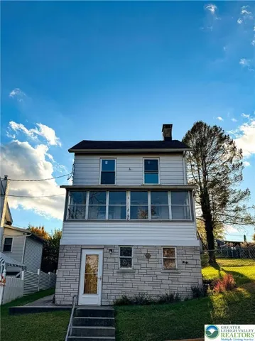 front view of a house with a yard