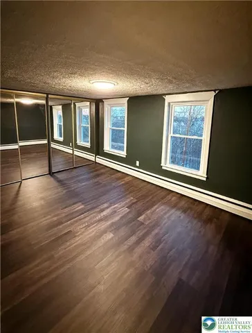 en empty room with wooden floor and sliding door