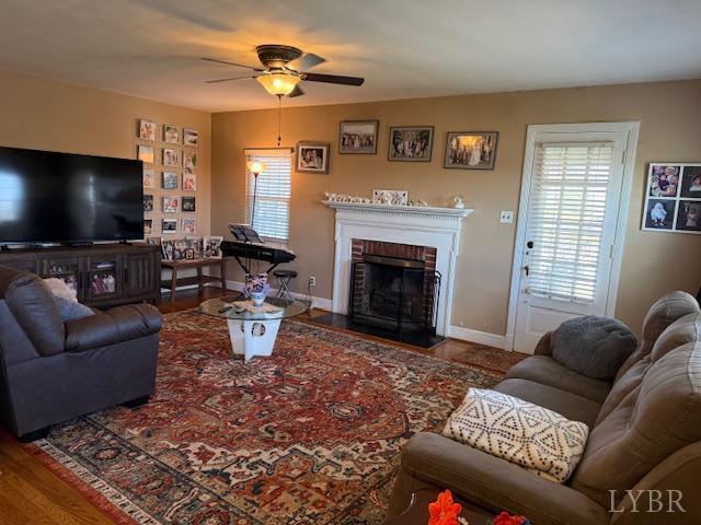153 Ridge Street Madison Heights, VA 24572 - Photo 11 of 26 a living room with furniture a flat screen tv and a fireplace