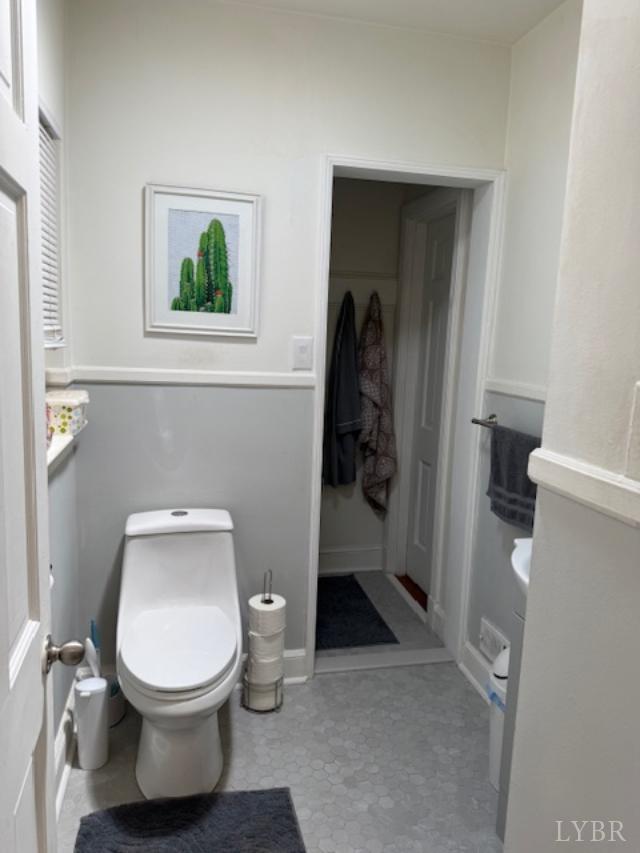 153 Ridge Street Madison Heights, VA 24572 - Photo 17 of 26 a white toilet sitting in a bathroom next to a window