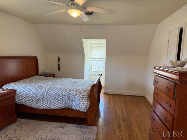 153 Ridge Street Madison Heights, VA 24572 - Photo 21 of 26 a bedroom with a bed and wooden floor