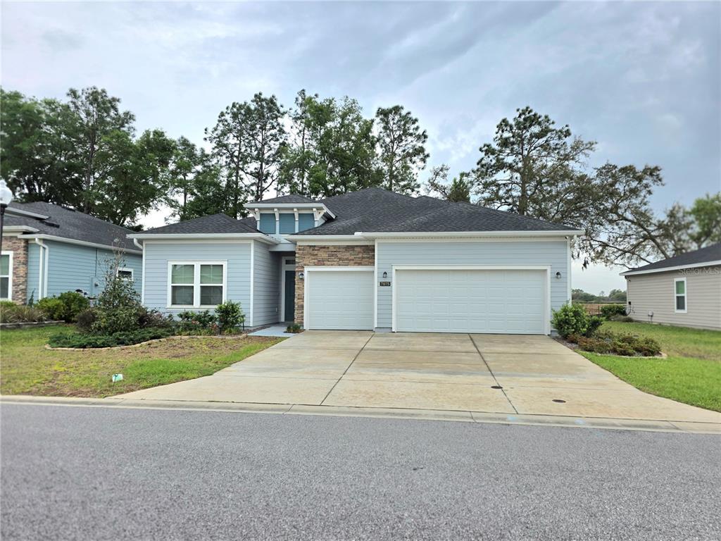 7875 Southwest 74th Street Ocala, FL 34474 - Photo 1 of 28 front view of house with a yard and potted plants
