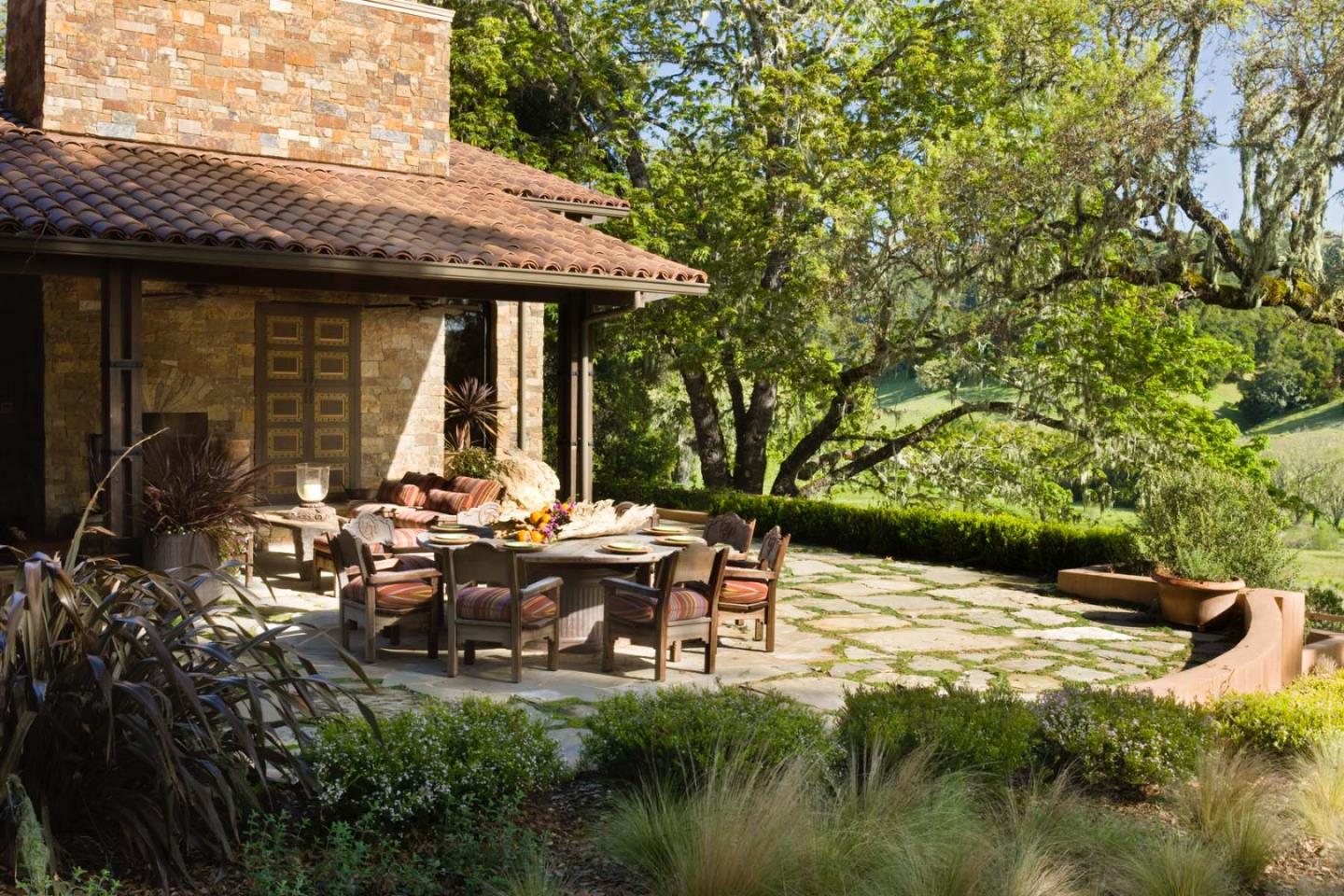 4 Rumsen Trace Carmel, CA 93923 - Photo 3 of 15 a backyard of a house with table and chairs