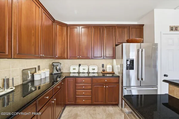 a kitchen with sink a refrigerator and cabinets