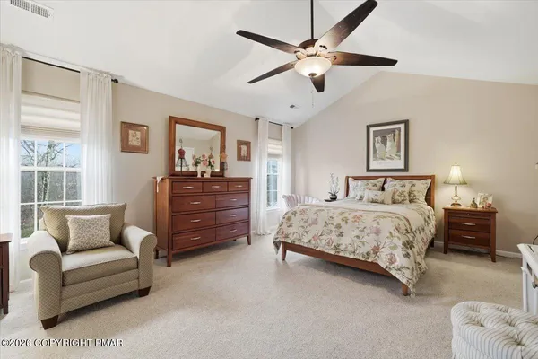 a bedroom with a bed and lamp