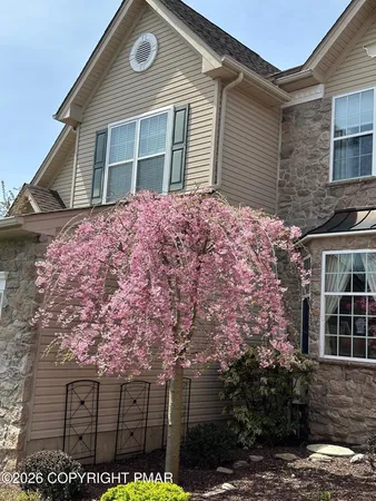 a front view of a house with a garden