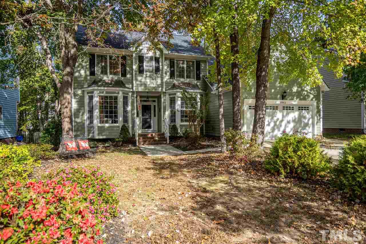 11912 Fairlie Place Raleigh, NC 27613 - Photo 1 of 25 a front view of a house with a yard