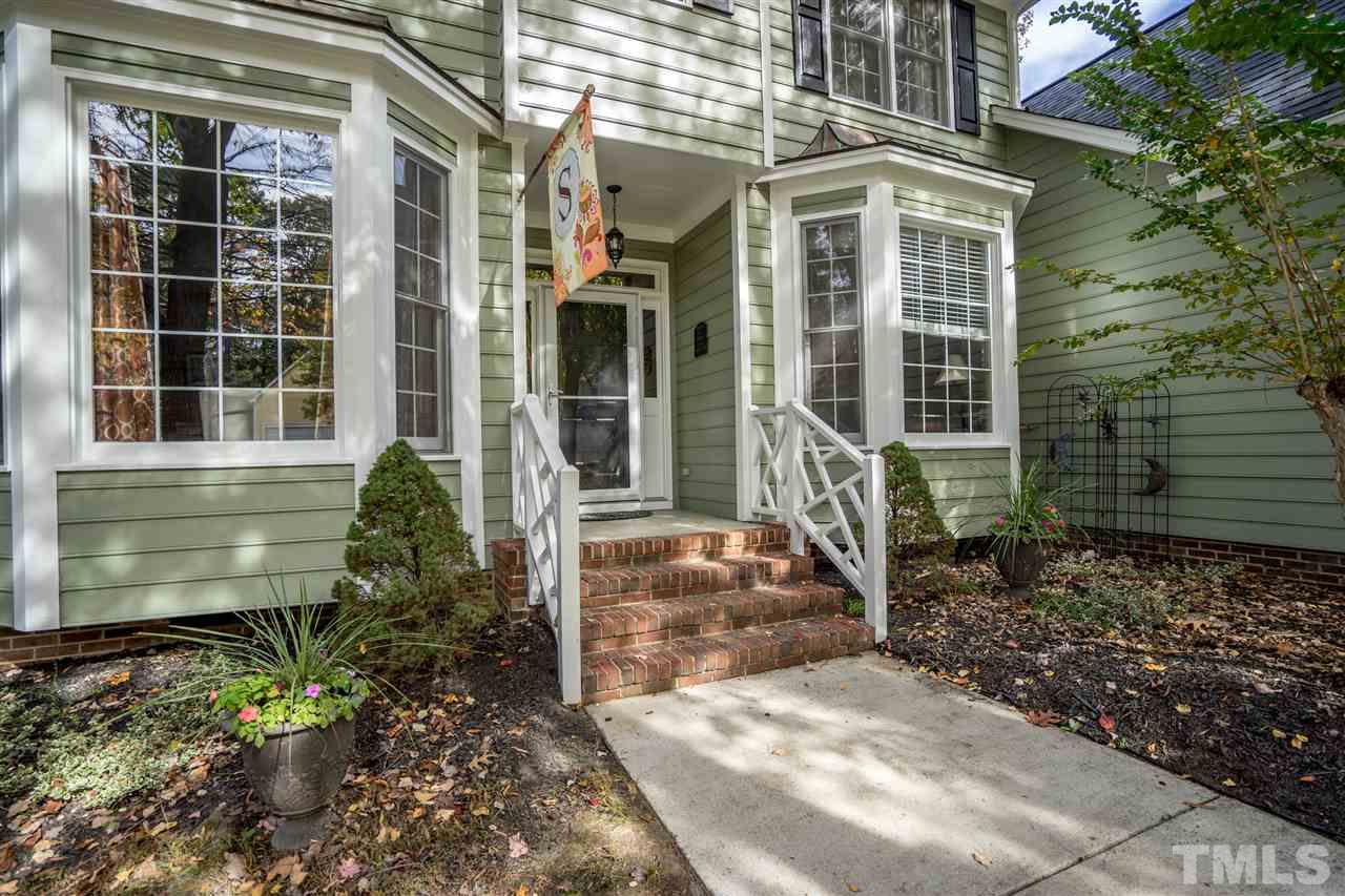 11912 Fairlie Place Raleigh, NC 27613 - Photo 2 of 25 a view of a brick house with large windows