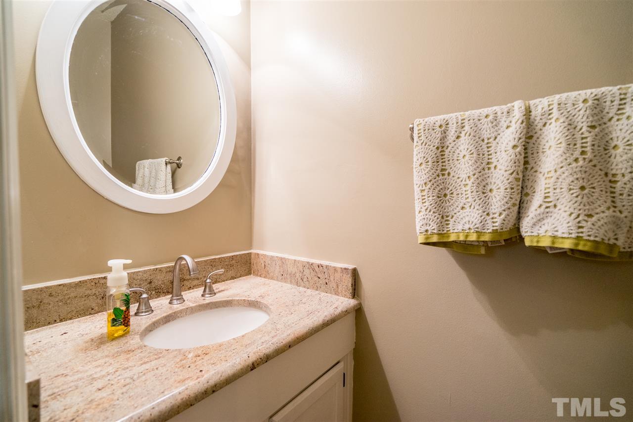 11912 Fairlie Place Raleigh, NC 27613 - Photo 17 of 25 a bathroom with a granite countertop sink and a mirror