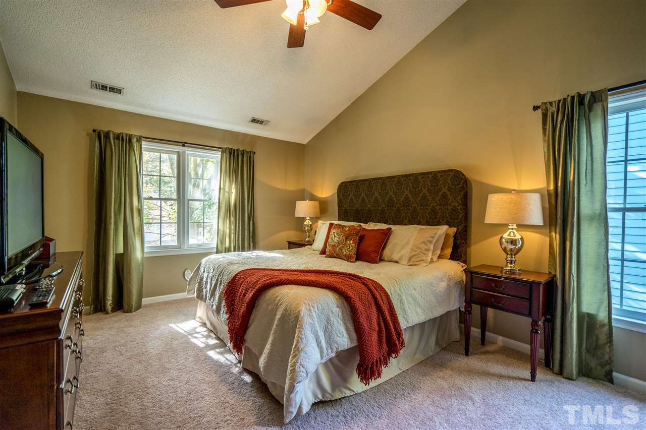 11912 Fairlie Place Raleigh, NC 27613 - Photo 18 of 25 a bed sitting in a bedroom next to a window