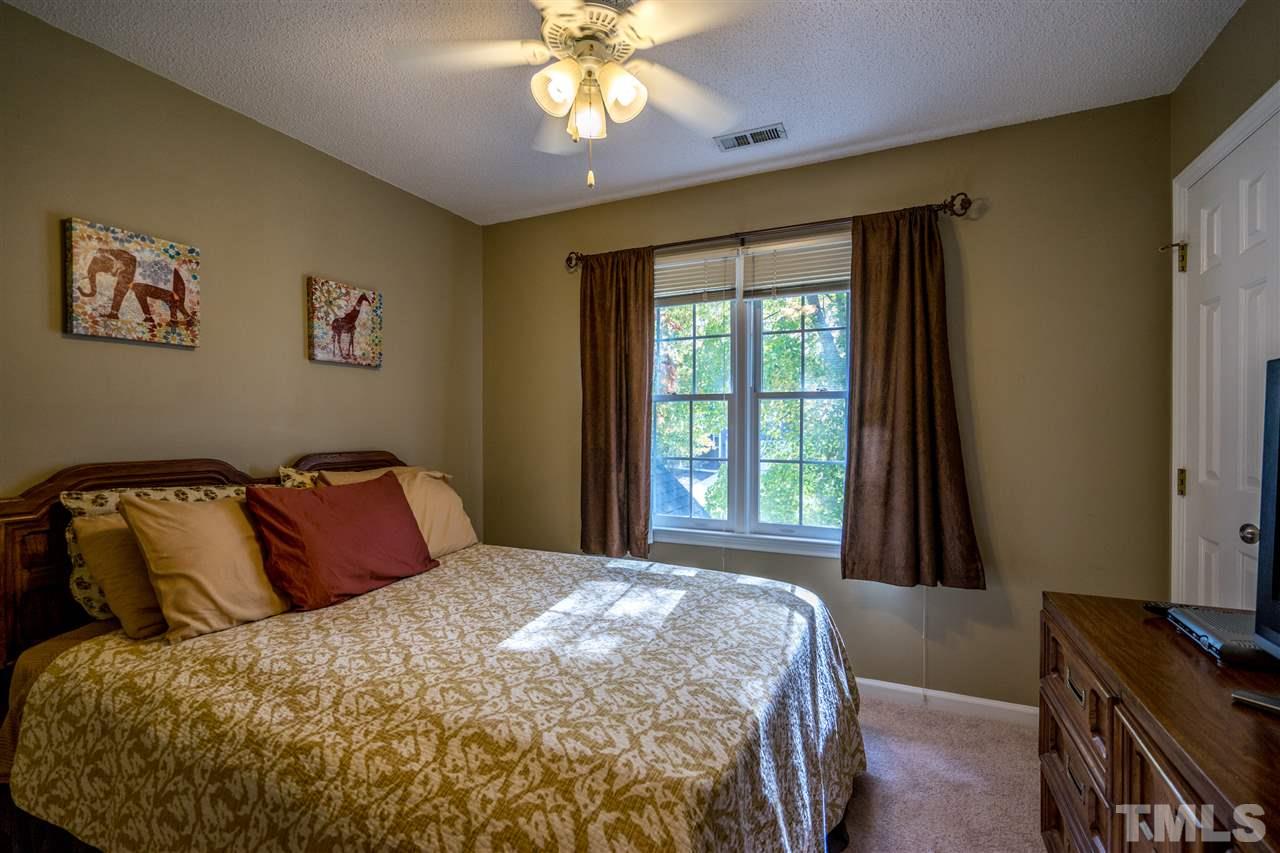 11912 Fairlie Place Raleigh, NC 27613 - Photo 20 of 25 a bedroom with a bed and a window