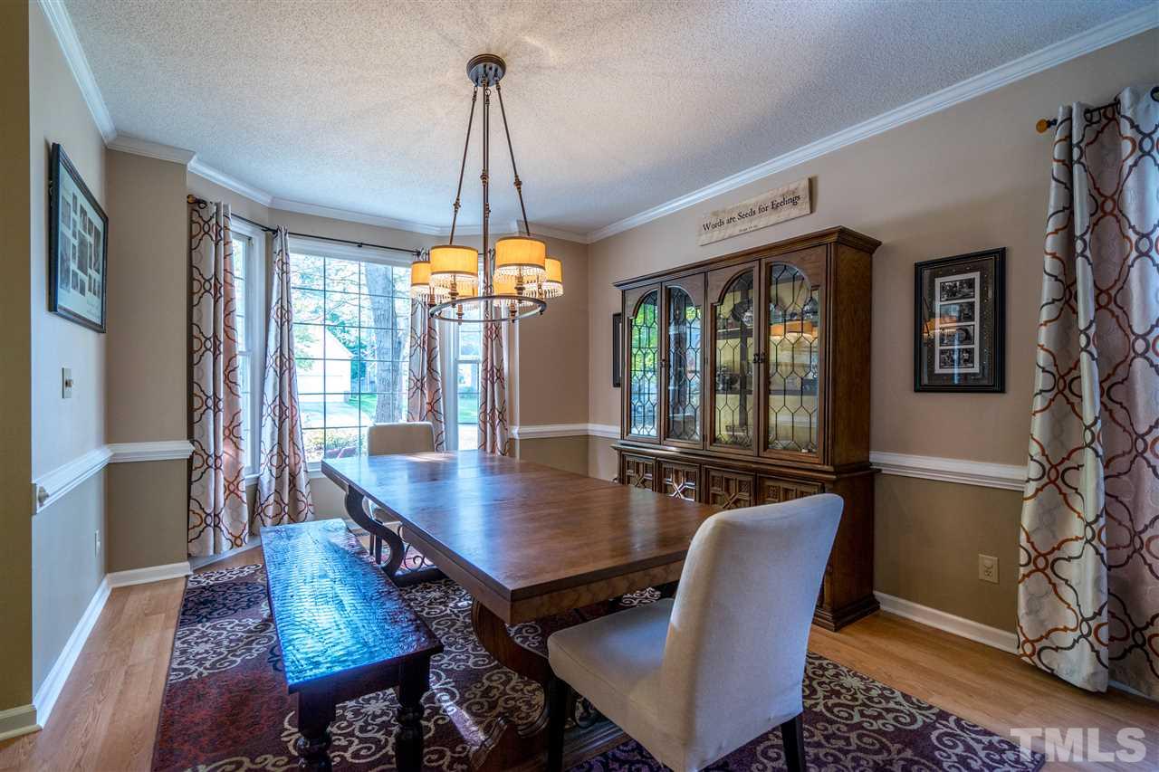 11912 Fairlie Place Raleigh, NC 27613 - Photo 5 of 25 a view of a dining room with furniture window and wooden floor
