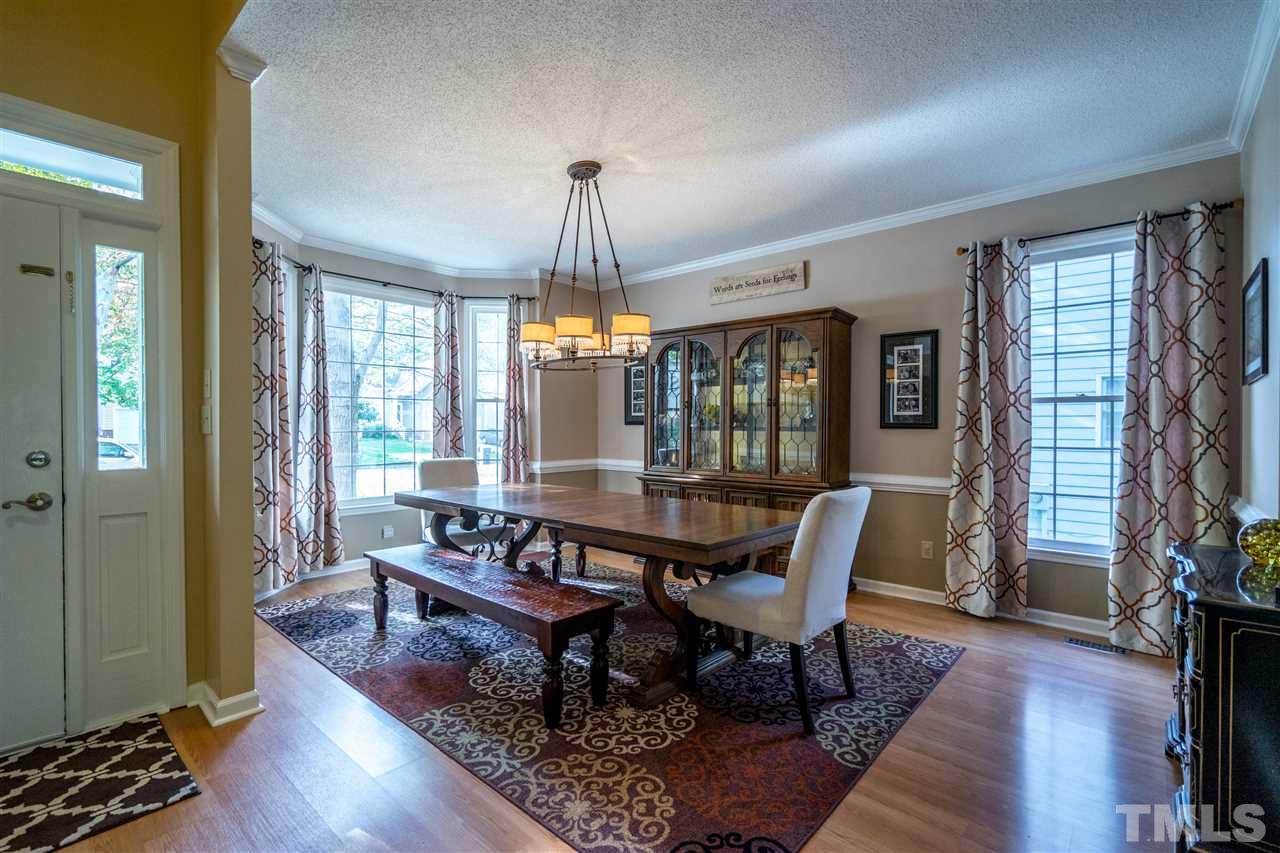 11912 Fairlie Place Raleigh, NC 27613 - Photo 6 of 25 a view of a dining room with furniture window and wooden floor