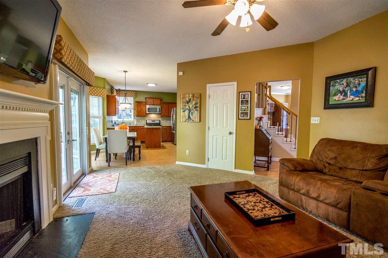 11912 Fairlie Place Raleigh, NC 27613 - Photo 10 of 25 a living room with furniture and a fireplace