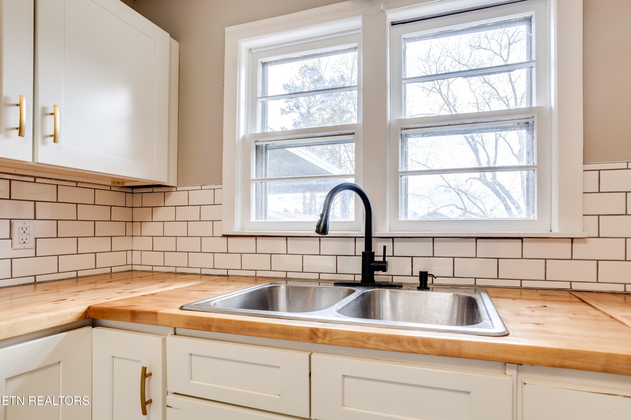 5715 Brown Gap Road Knoxville, TN 37918 - Photo 11 of 37 a kitchen with a sink and cabinets next to a window
