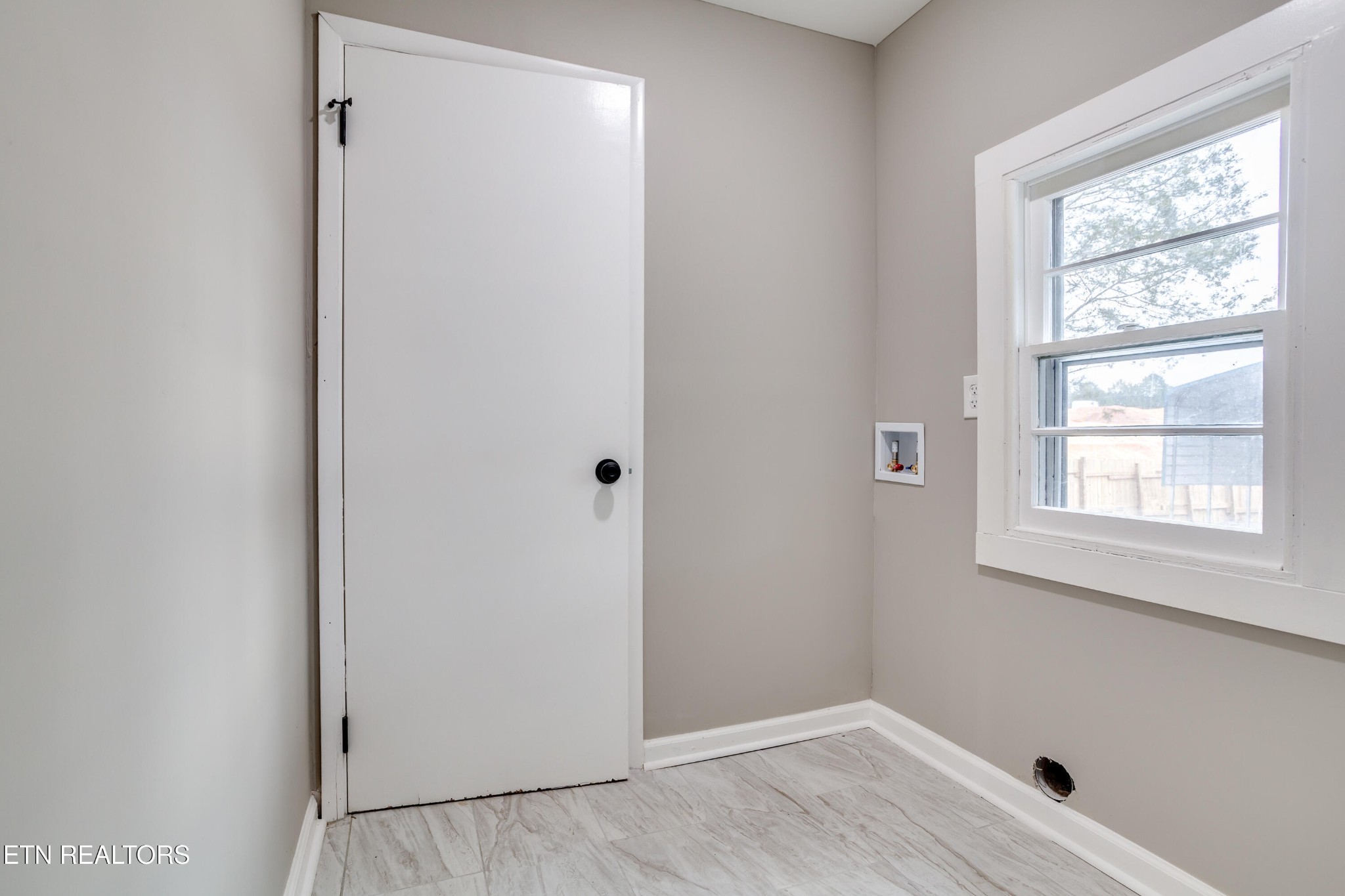 5715 Brown Gap Road Knoxville, TN 37918 - Photo 15 of 37 a view of an empty room with wooden floor and a window