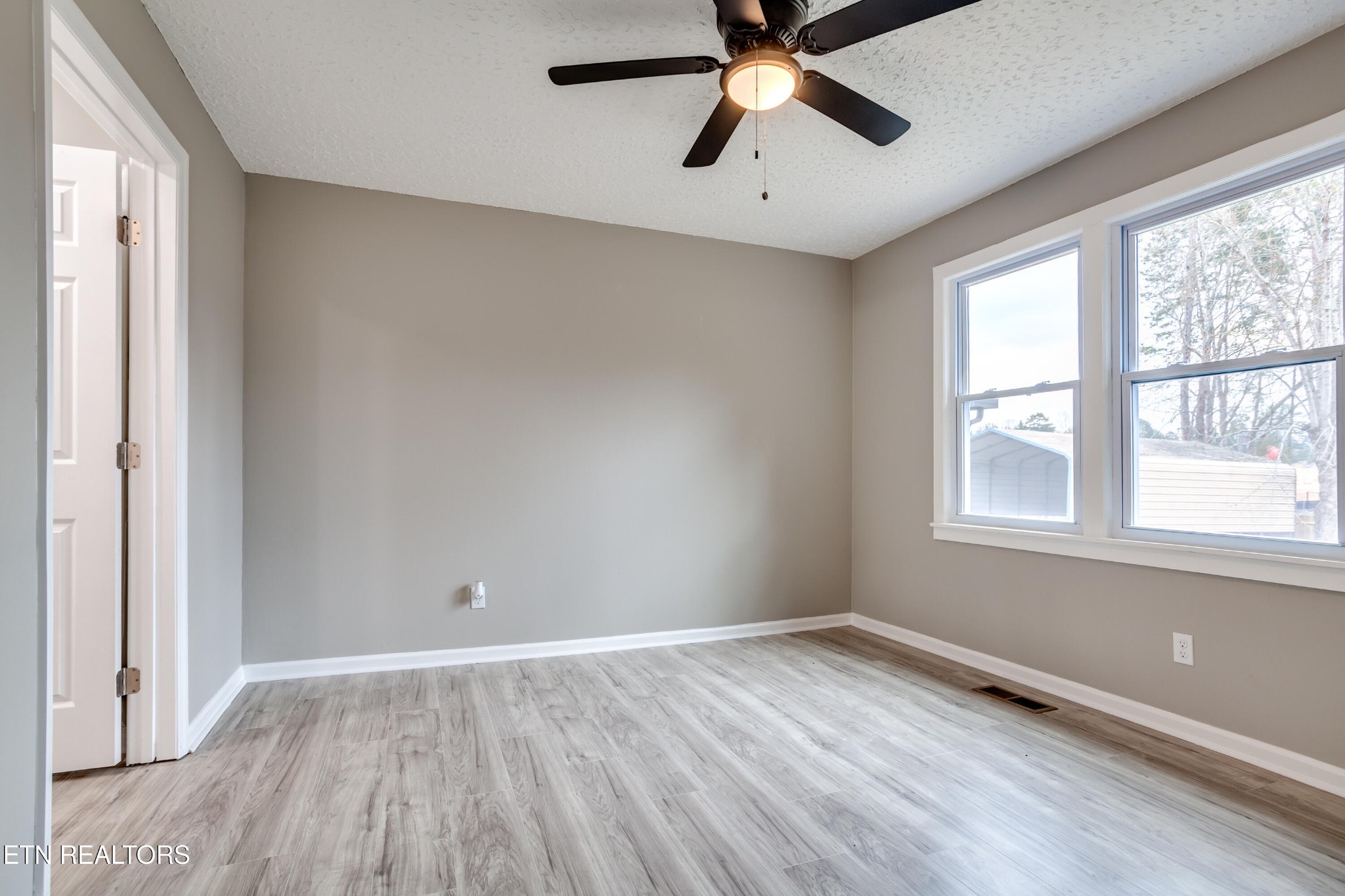 5715 Brown Gap Road Knoxville, TN 37918 - Photo 19 of 37 wooden floor in an empty room with a window