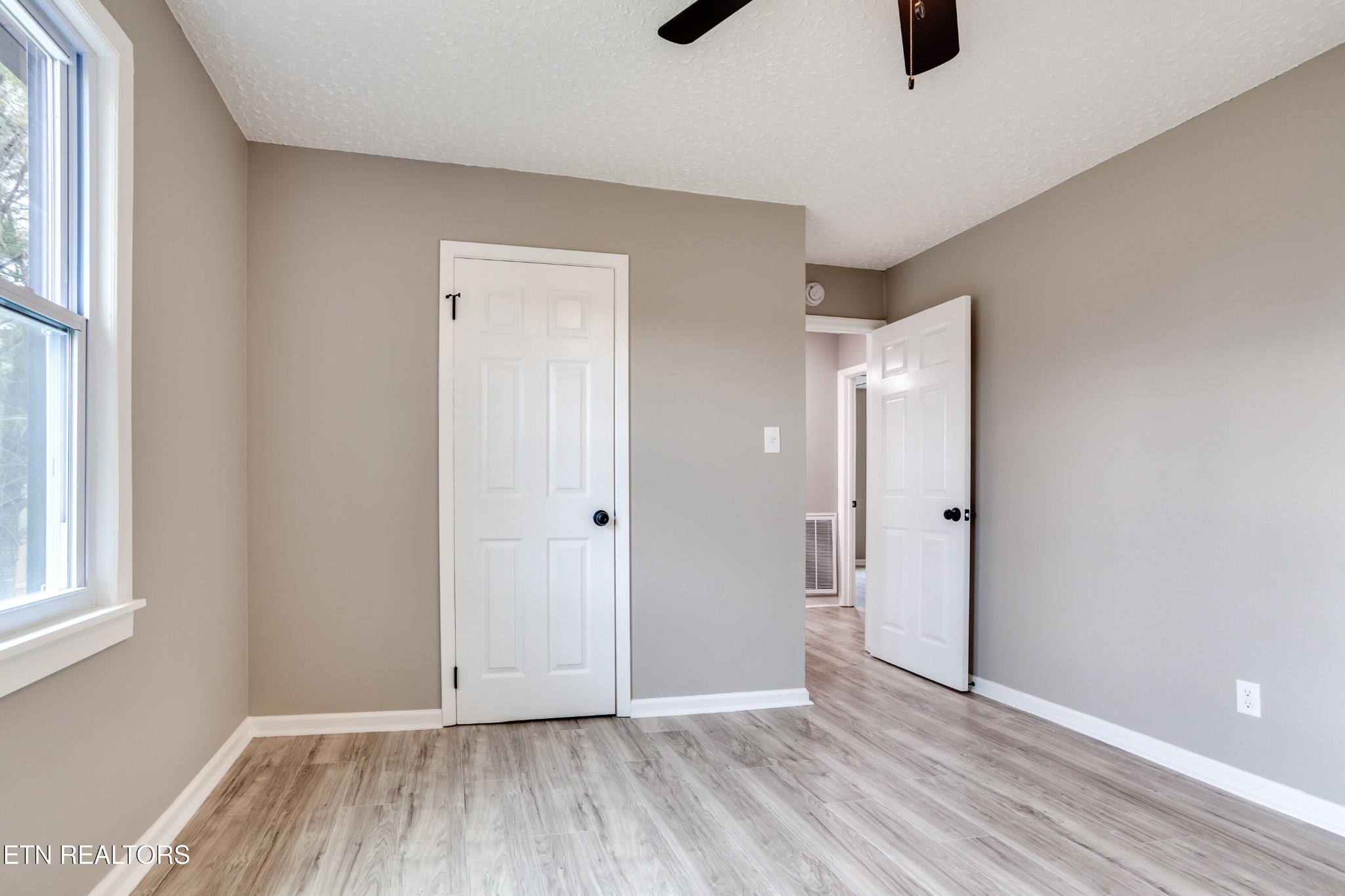5715 Brown Gap Road Knoxville, TN 37918 - Photo 21 of 37 a view of an empty room with wooden floor and a window