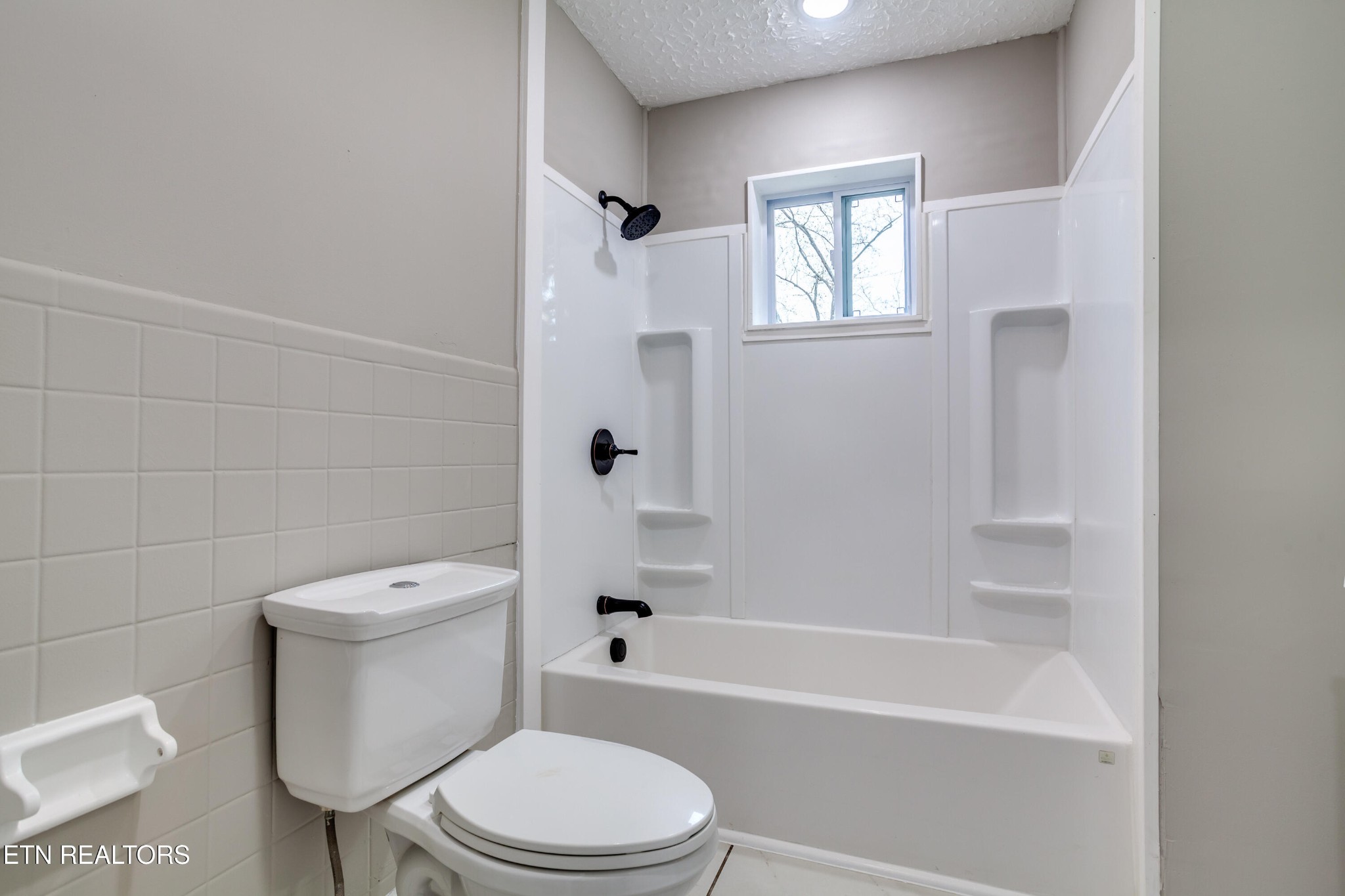 5715 Brown Gap Road Knoxville, TN 37918 - Photo 25 of 37 a white toilet and a bath tub sitting in a bathroom