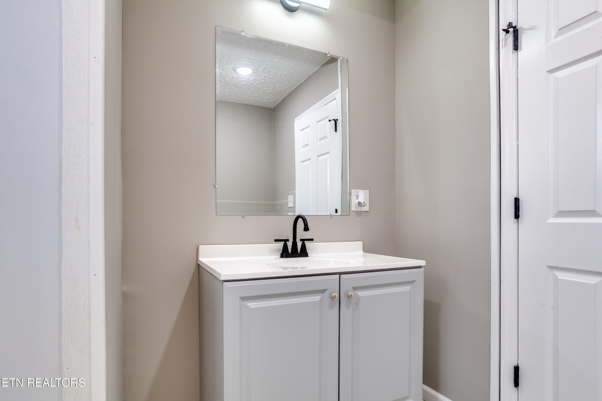 5715 Brown Gap Road Knoxville, TN 37918 - Photo 26 of 37 a bathroom with a sink a mirror and vanity