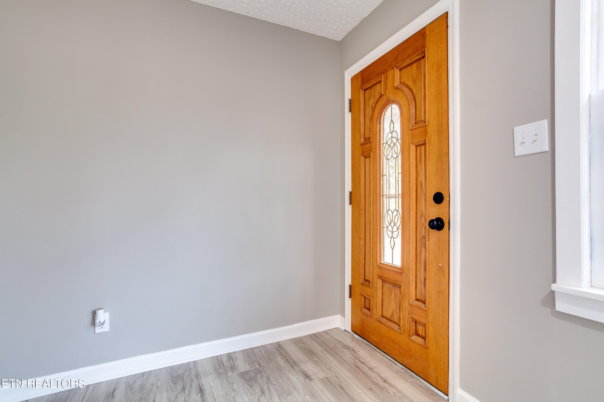 5715 Brown Gap Road Knoxville, TN 37918 - Photo 5 of 37 a view of an empty room with wooden floor and a window
