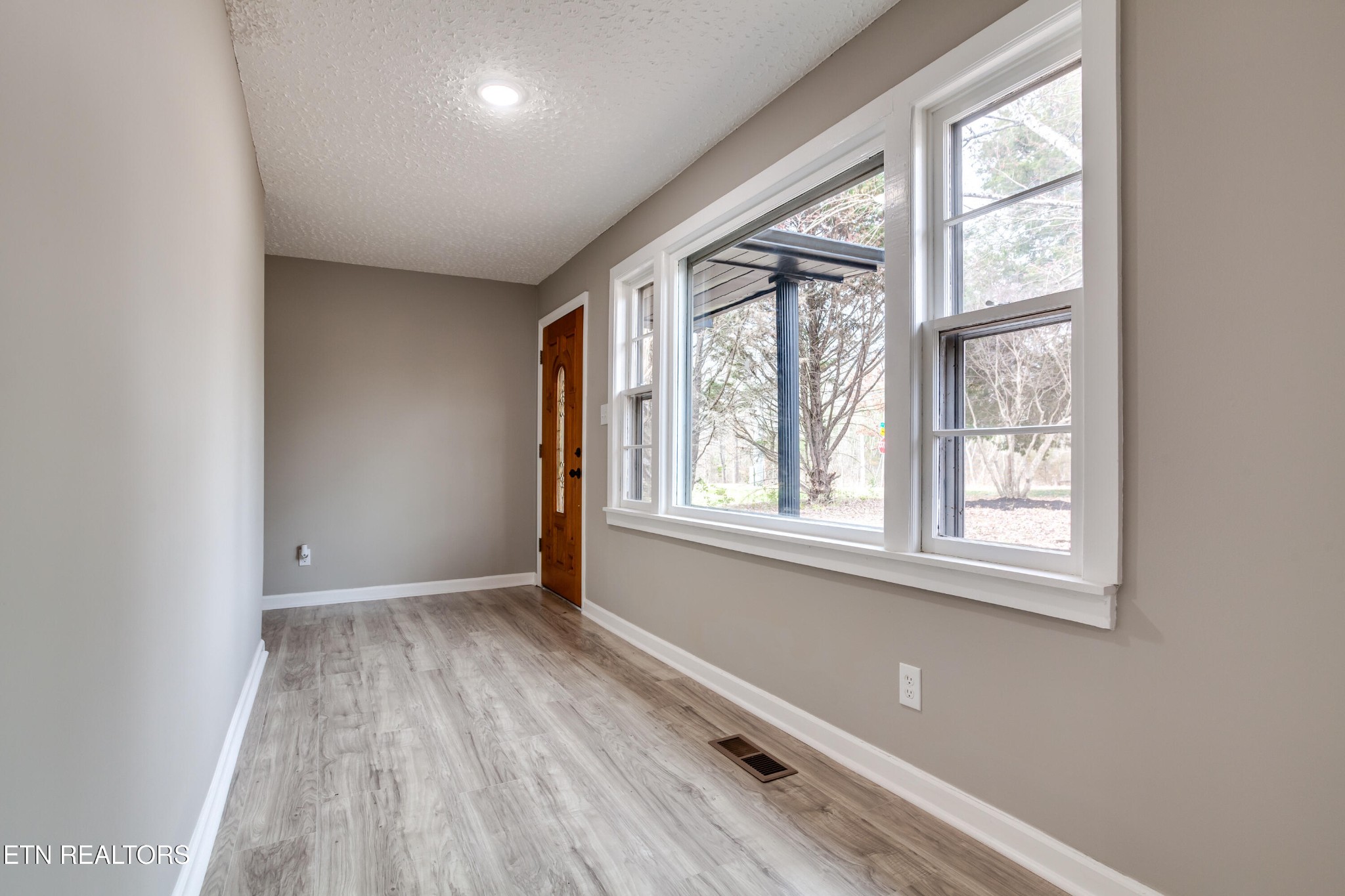 5715 Brown Gap Road Knoxville, TN 37918 - Photo 6 of 37 an empty room with wooden floor and windows