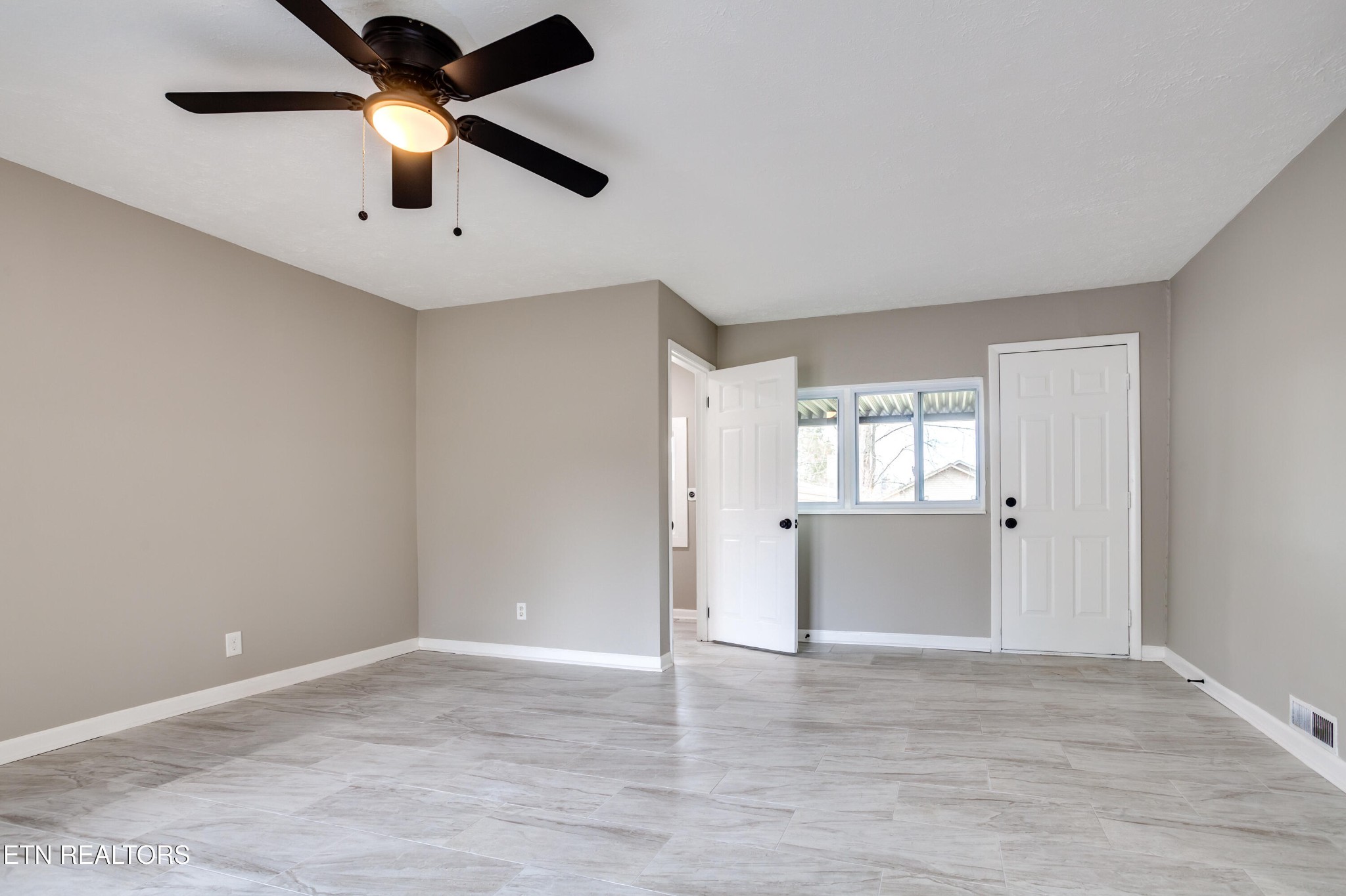 5715 Brown Gap Road Knoxville, TN 37918 - Photo 10 of 37 an empty room with wooden floor and windows