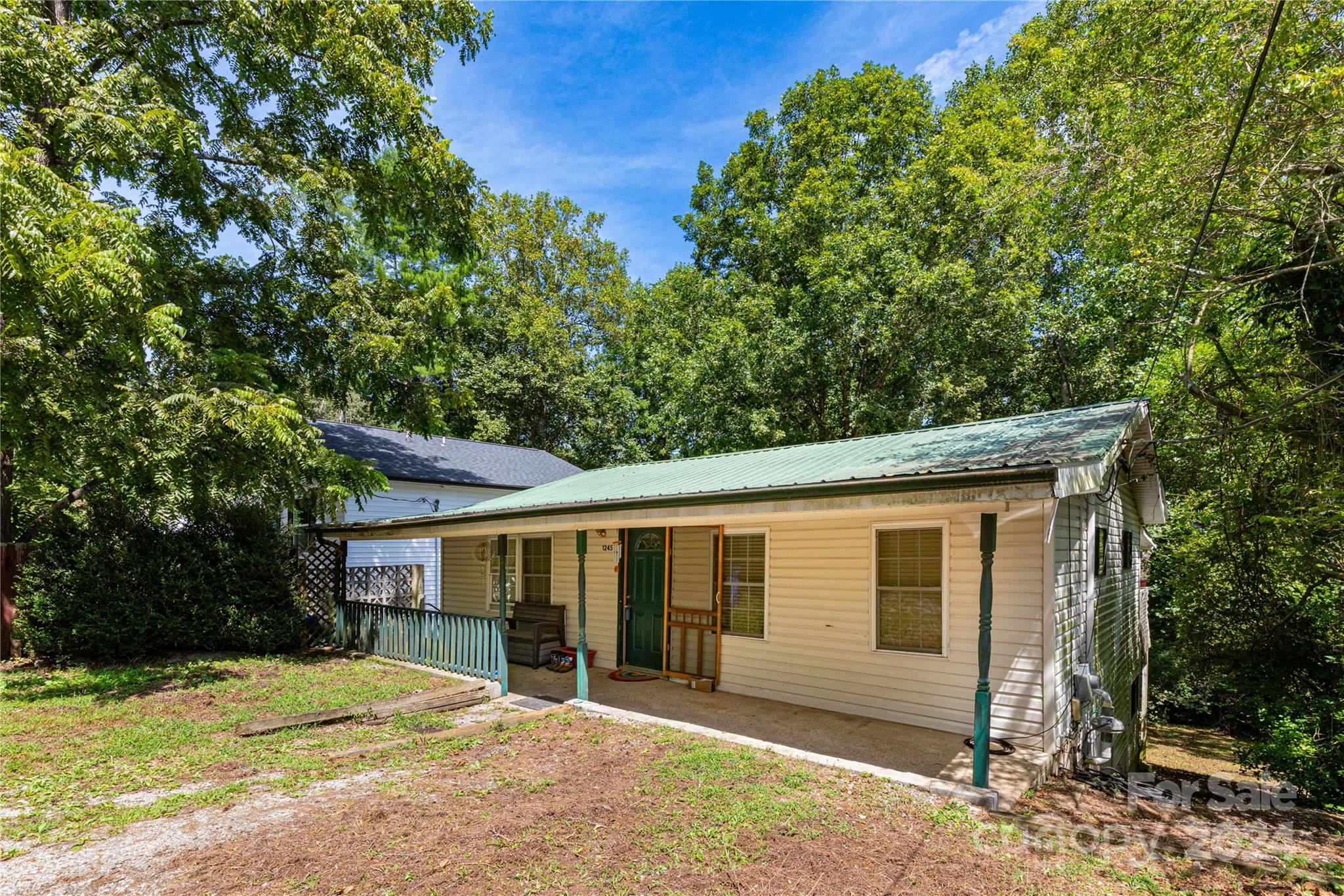 1245 Pine Spring Drive Hendersonville, NC 28739 - Photo 2 of 20 a front view of a house with a yard
