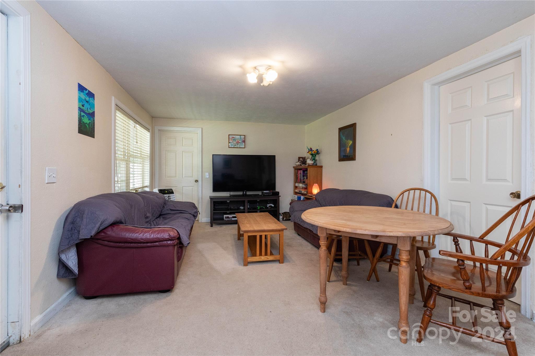 1245 Pine Spring Drive Hendersonville, NC 28739 - Photo 5 of 20 a living room with furniture and a flat screen tv