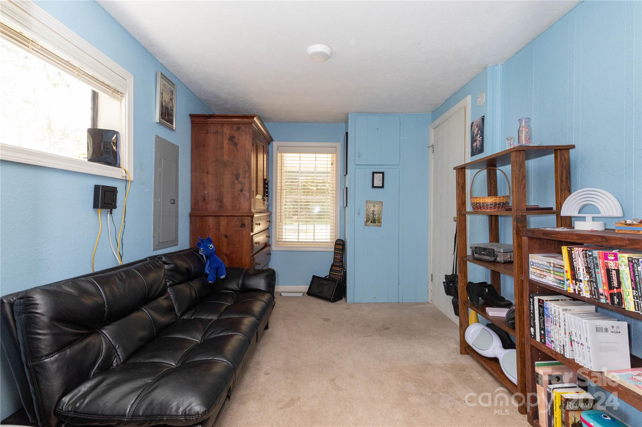 1245 Pine Spring Drive Hendersonville, NC 28739 - Photo 8 of 20 a living room with furniture a window and book shelf