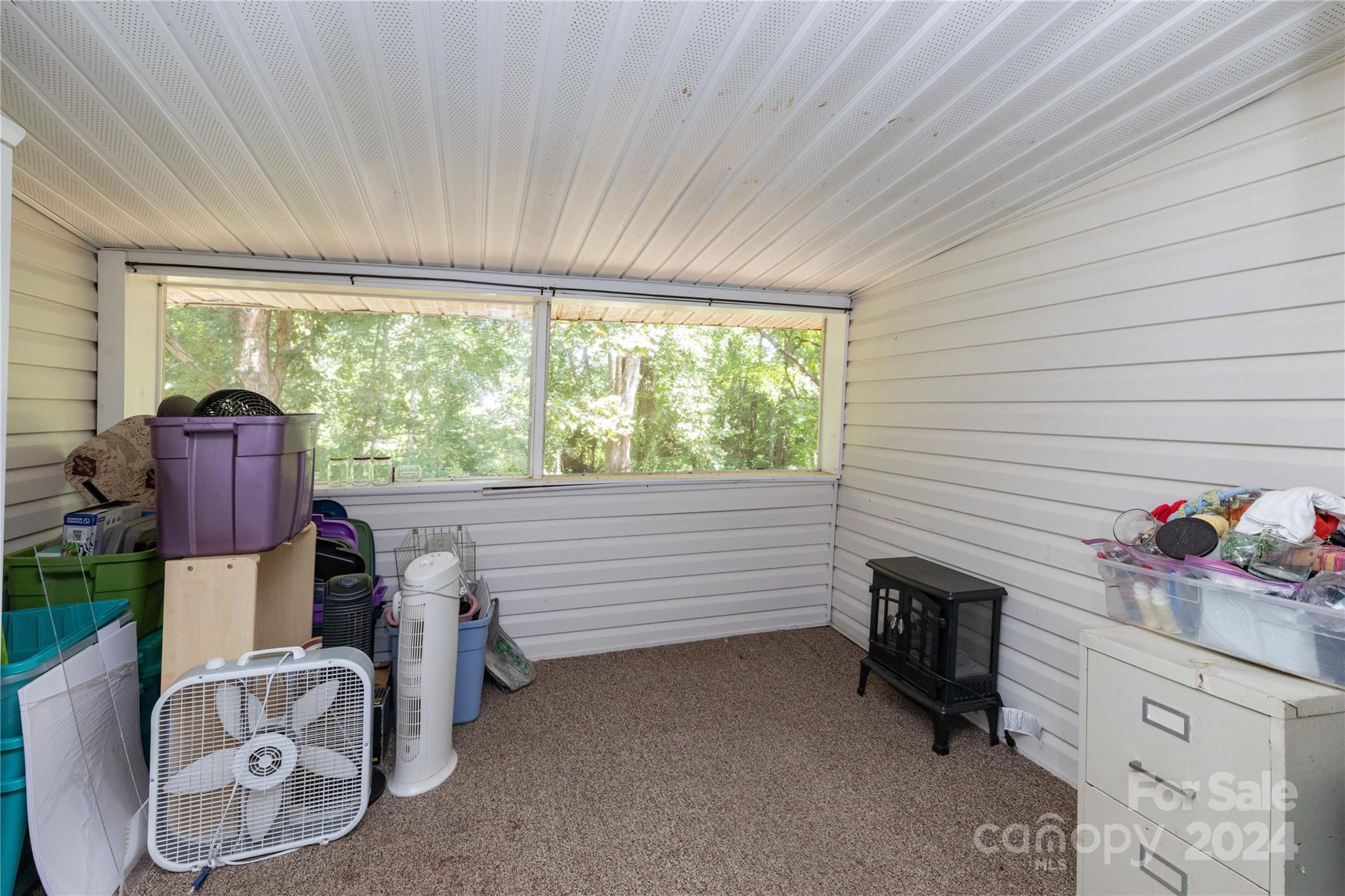 1245 Pine Spring Drive Hendersonville, NC 28739 - Photo 10 of 20 a view of a livingroom with furniture and windows