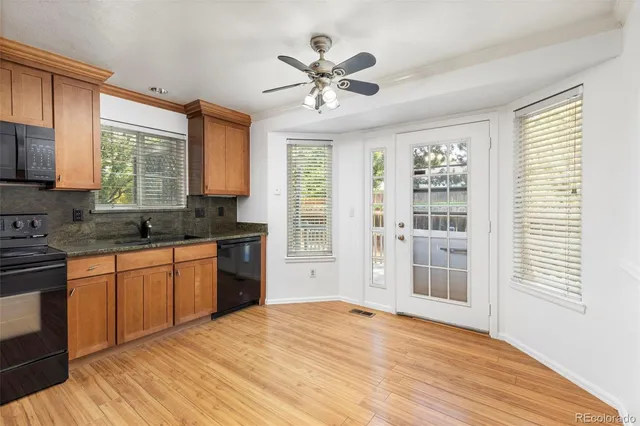 a open kitchen with granite countertop a stove sink and cabinets