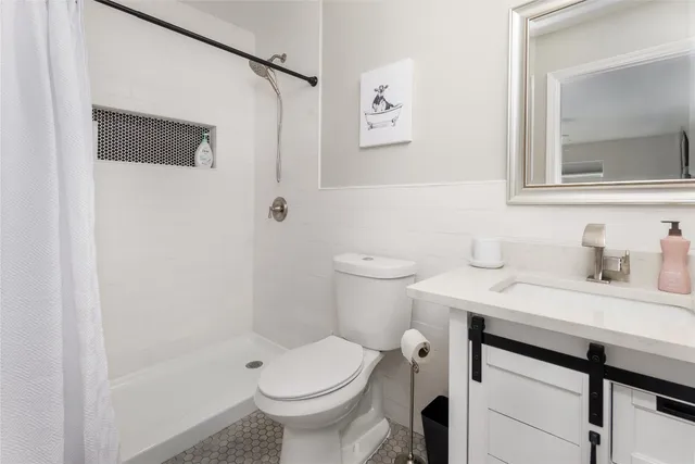 a bedroom with two beds and a chandelier