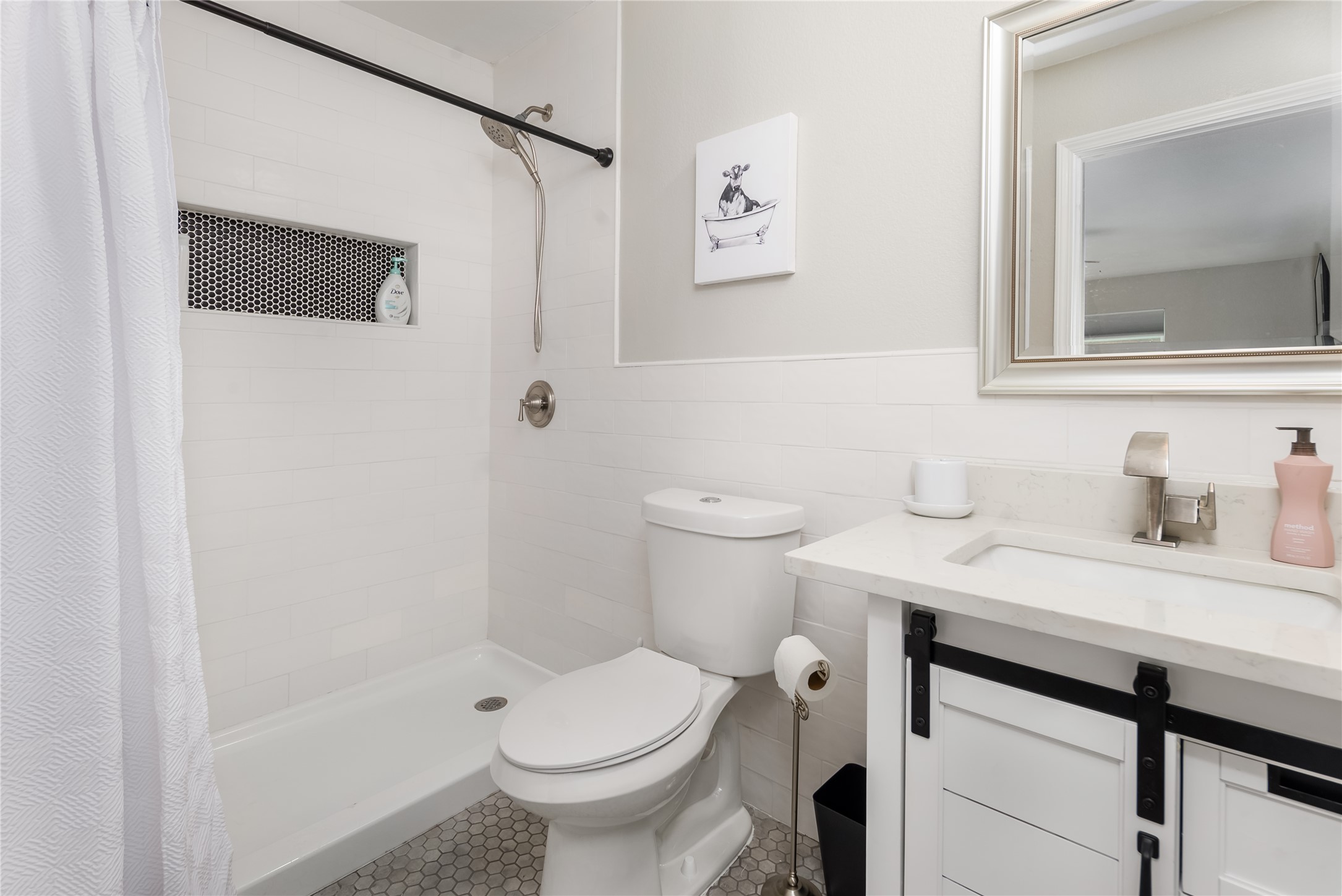 1651 Chippeway Lane Austin, TX 78745 - Photo 17 of 26 a bathroom with a sink a toilet and shower