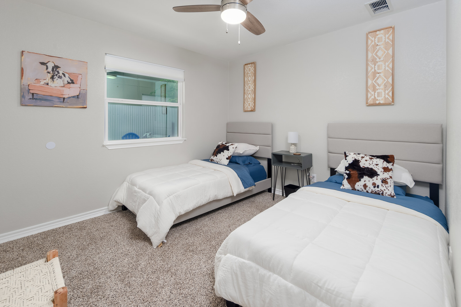 1651 Chippeway Lane Austin, TX 78745 - Photo 18 of 26 a bedroom with two beds and a chandelier