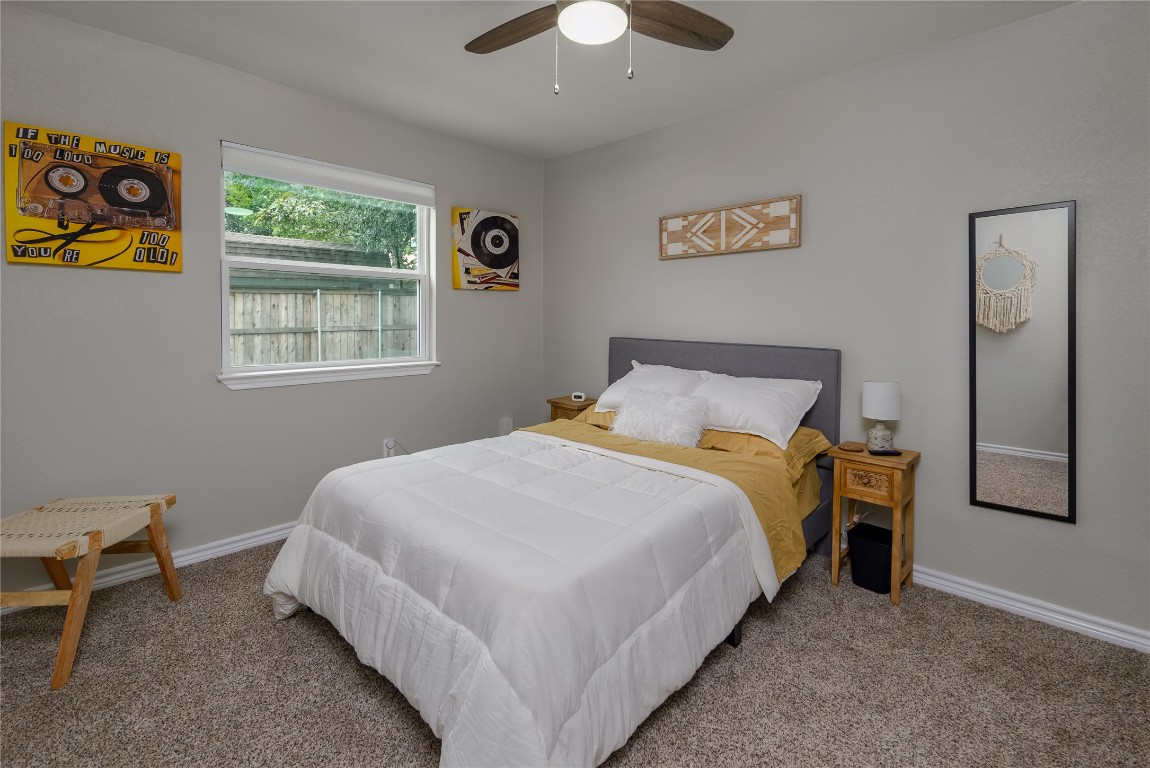1651 Chippeway Lane Austin, TX 78745 - Photo 19 of 26 a bedroom with a bed and a chandelier