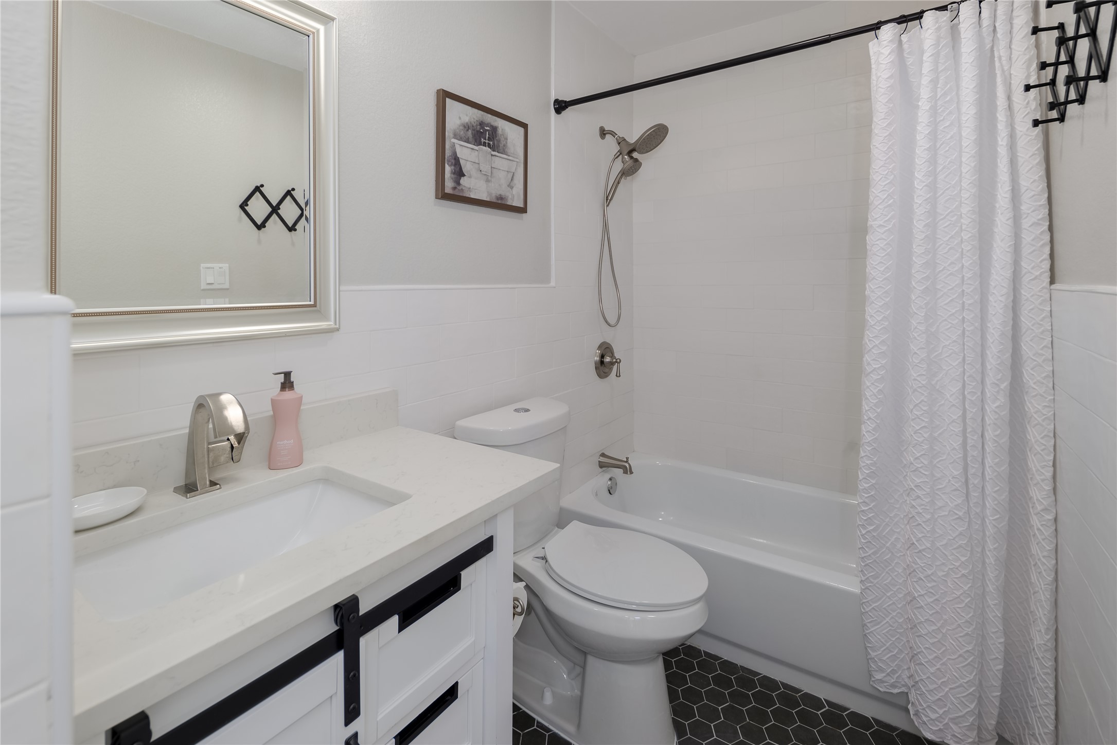 1651 Chippeway Lane Austin, TX 78745 - Photo 20 of 26 a bathroom with a sink a toilet and shower
