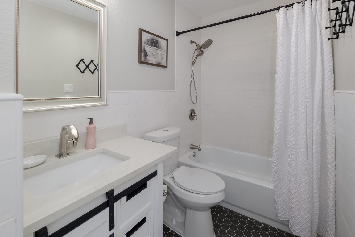 1651 Chippeway Lane Austin, TX 78745 - Photo 20 of 26 a bathroom with a sink a toilet and shower
