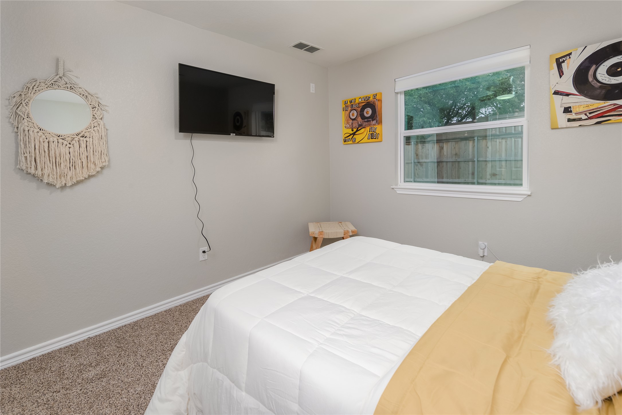 1651 Chippeway Lane Austin, TX 78745 - Photo 21 of 26 a bedroom with a bed a window and a flat screen tv