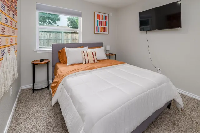 a white house that has a tree in front of it